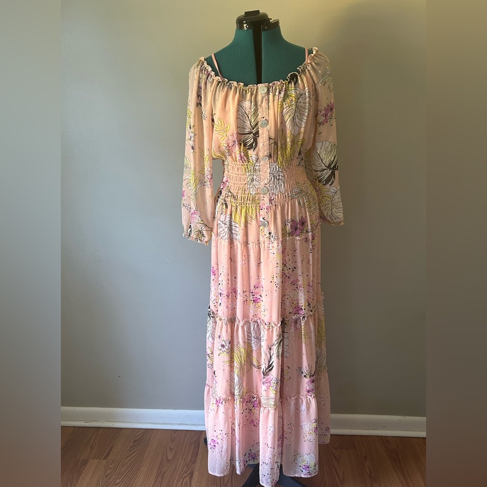Off the shoulder with a pink under dress, gold specks are all over the dress